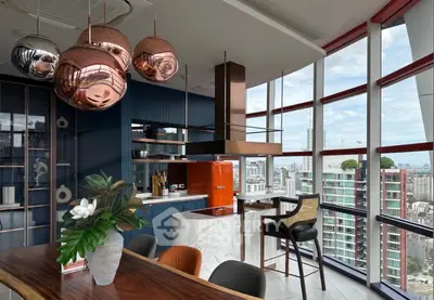 Luxurious modern kitchen with panoramic city views and stylish copper accents.