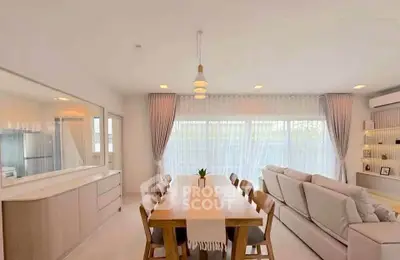 Spacious open-plan living and dining area with modern decor and natural light.