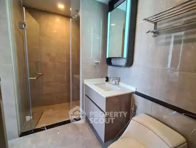 Modern bathroom with glass shower and sleek vanity in luxury apartment