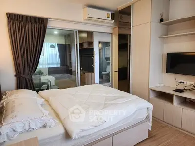 Modern bedroom with sliding glass doors and cozy decor