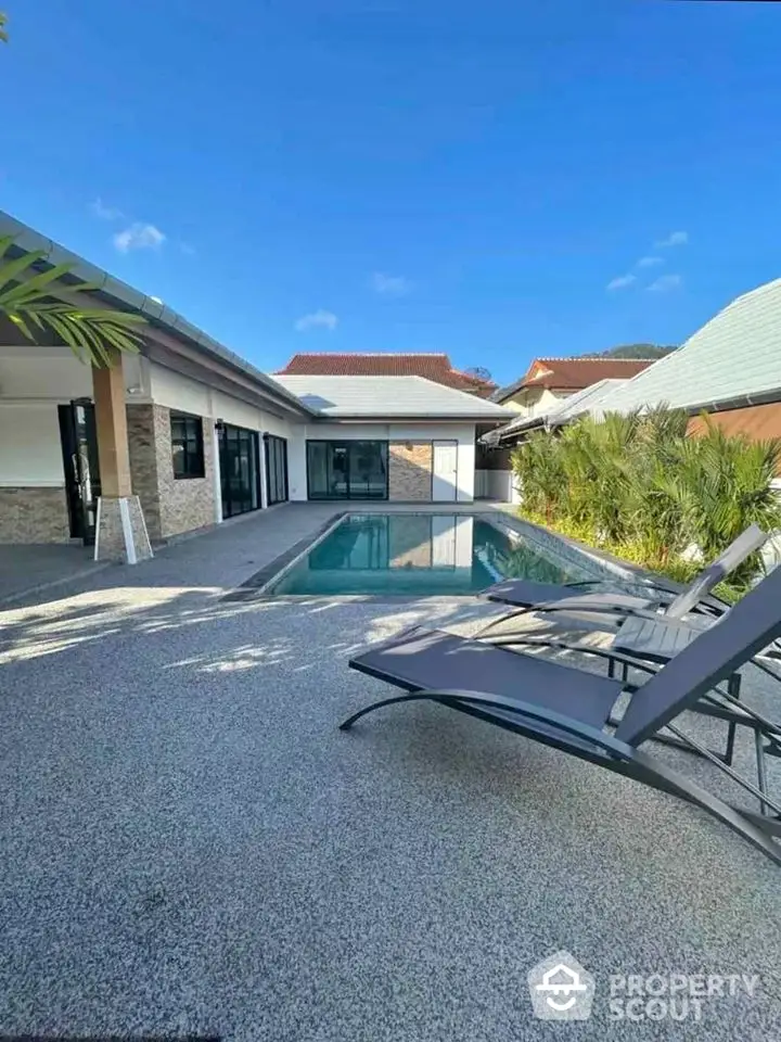 Luxurious villa with private pool and modern patio, perfect for relaxation and entertaining.