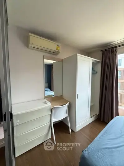 Cozy bedroom with modern furniture and natural light, perfect for comfortable living.