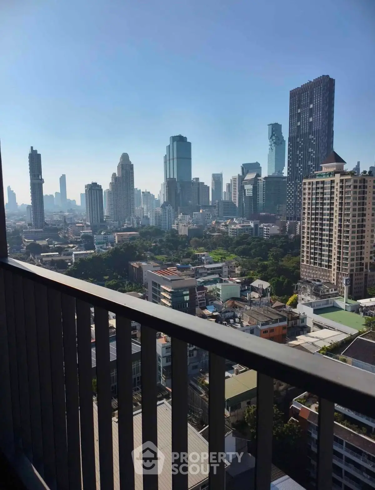 Stunning cityscape view from a high-rise balcony overlooking urban skyline.