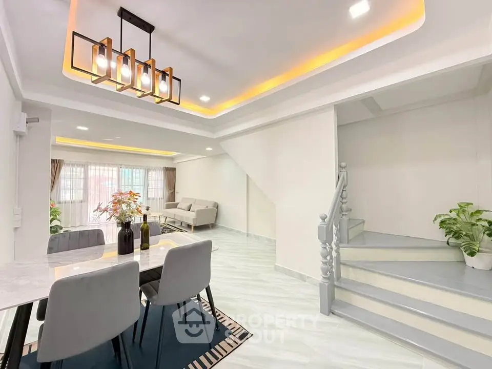Modern living room with elegant dining area and stylish lighting