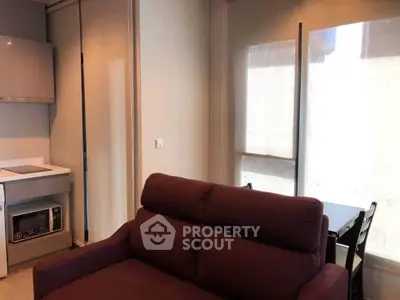 Modern living room with cozy sofa and dining area in a stylish apartment.