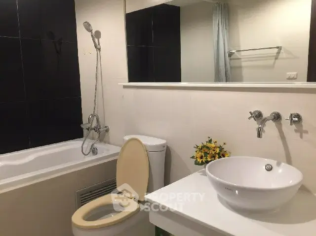 Modern bathroom with sleek fixtures and a bathtub, perfect for relaxation.