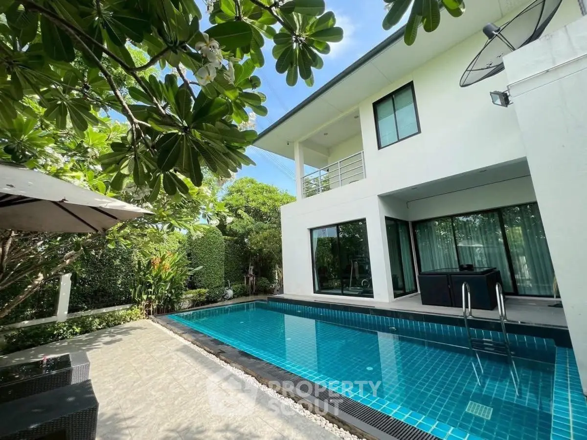 Modern villa with private pool and lush garden, perfect for luxury living.