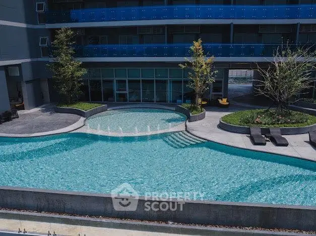 Luxurious apartment complex with stunning outdoor pool and modern design.