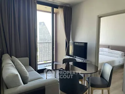 Modern living room with balcony view and adjacent bedroom in stylish apartment.