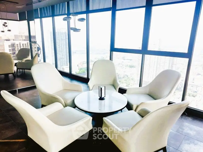 Luxurious high-rise building lounge with panoramic city views and elegant seating area.