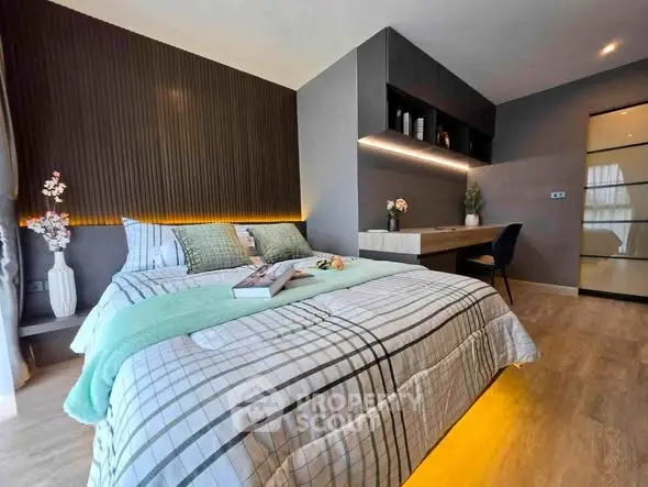 Modern bedroom with stylish decor and ambient lighting, featuring a cozy bed and sleek workspace.