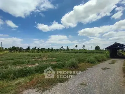 Expansive rural land with lush greenery and clear blue skies, perfect for development or agriculture.