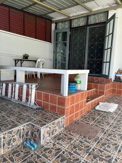 Charming patio area with tiled flooring and outdoor seating, perfect for relaxation.