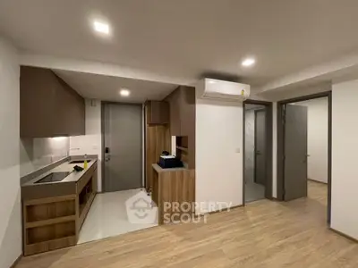 Modern kitchen with sleek cabinetry and open layout in contemporary apartment.