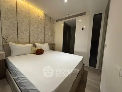 Luxurious modern bedroom with elegant lighting and plush bedding