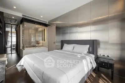 Luxurious modern bedroom with ensuite bathroom and sleek metallic wall design.