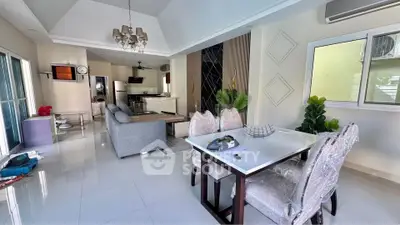 Spacious open-plan living and dining area with modern decor and natural light.