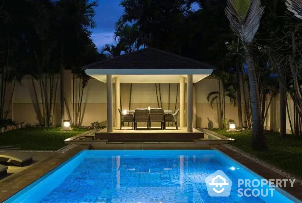 Luxurious backyard pool with elegant gazebo and ambient lighting for perfect evening relaxation.