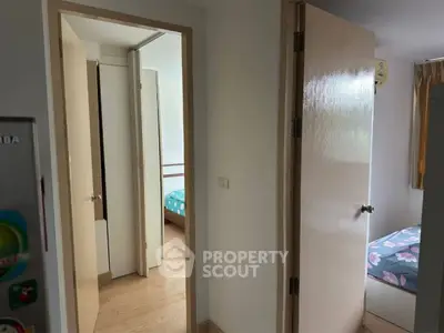 Cozy interior with wooden flooring and bedroom view, perfect for modern living.