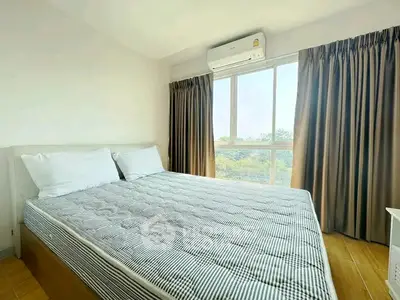 Bright and airy bedroom with large window and air conditioning unit