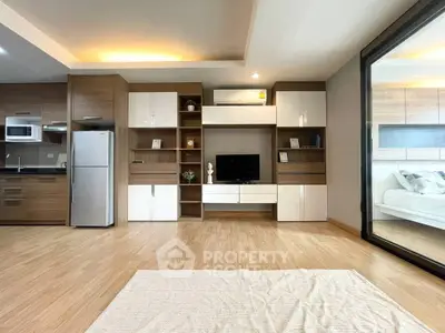 Modern open-plan living room with sleek kitchen and stylish decor