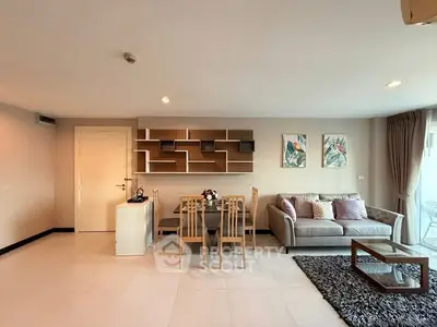 Modern living room with stylish decor, cozy sofa, and elegant dining area in open layout apartment.