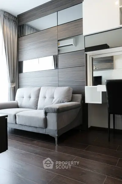 Modern living room with stylish sofa and wooden flooring