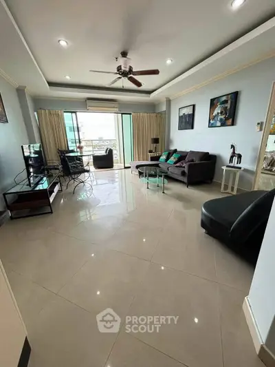 Spacious living room with modern decor and large windows offering natural light.