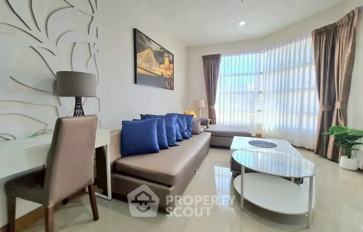 Modern living room with stylish decor and large windows for natural light.