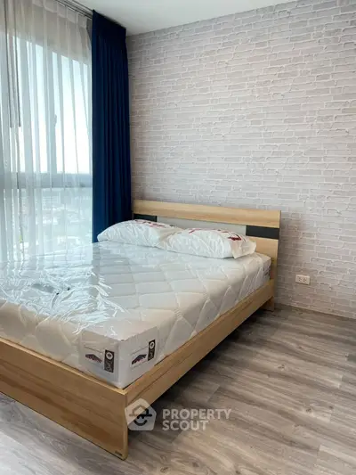 Modern bedroom with stylish brick wall and large window