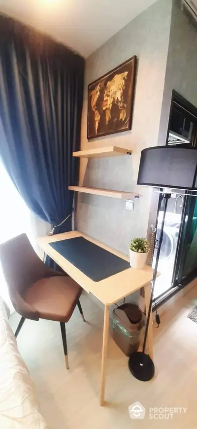 Modern study area with sleek desk, chair, and wall shelves in a stylish apartment.