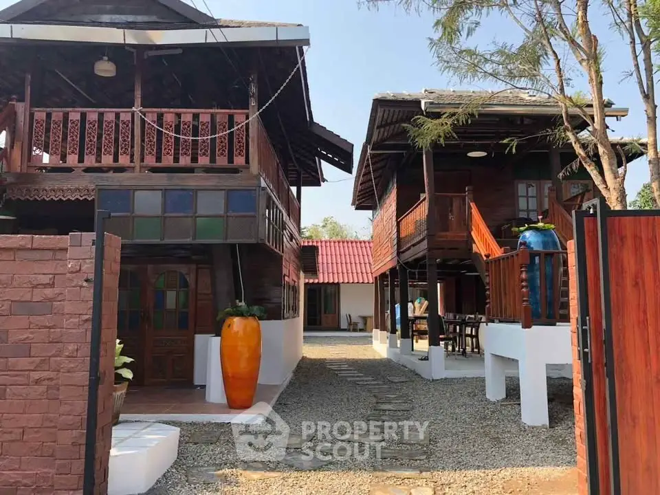 Charming traditional wooden houses with vibrant accents and spacious outdoor area.