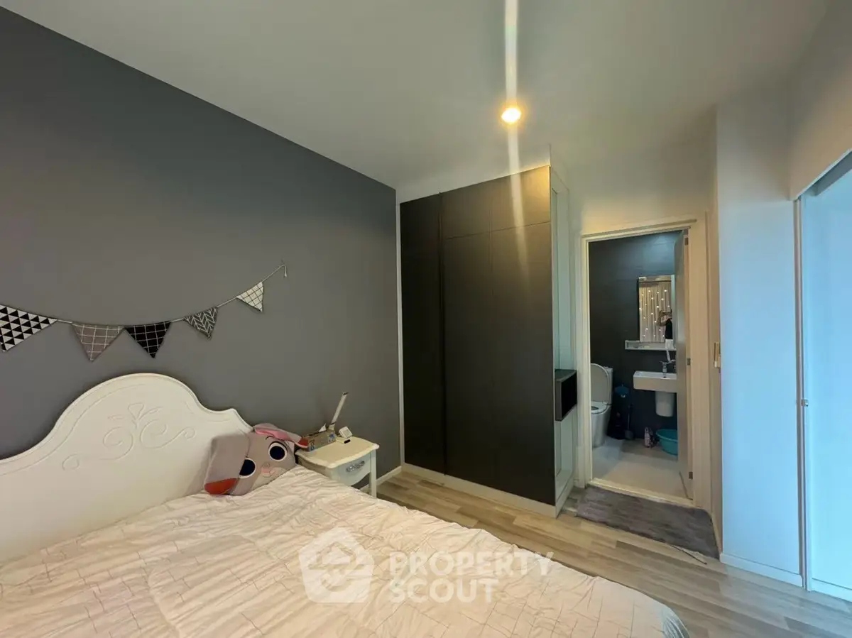 Cozy bedroom with modern decor and en-suite bathroom in stylish apartment