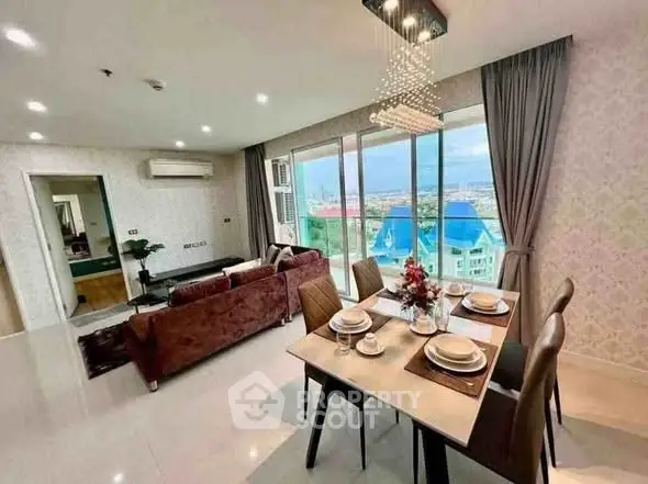 Luxurious open-plan living and dining area with stunning city view, modern decor, and elegant lighting.