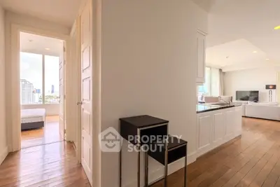 Spacious modern apartment with open layout and city view, featuring hardwood floors and elegant furnishings.