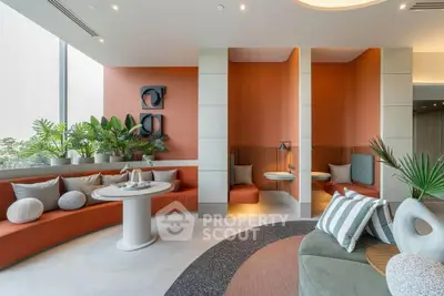 Modern living room with stylish seating and vibrant decor, featuring large windows and lush indoor plants.