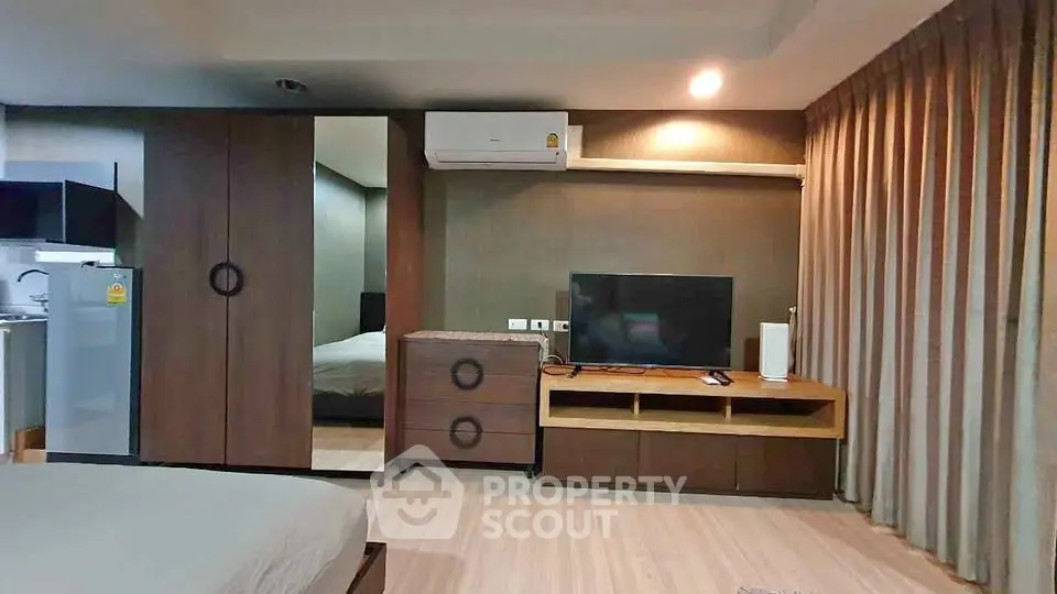 Modern bedroom with sleek furniture and air conditioning in a stylish apartment.