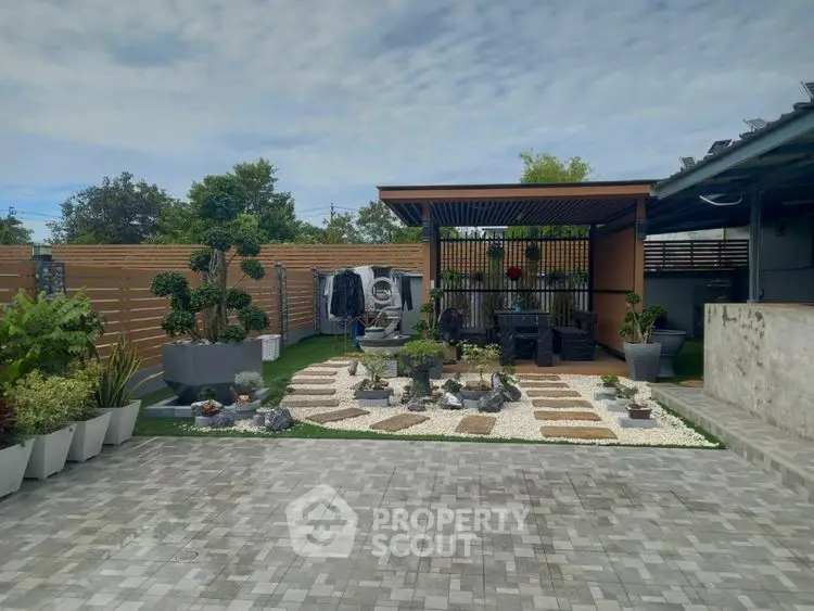 Beautifully landscaped garden with modern pergola and paved patio area.