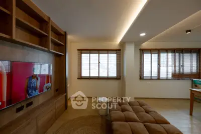 Spacious living room with modern wooden accents and cozy seating area.