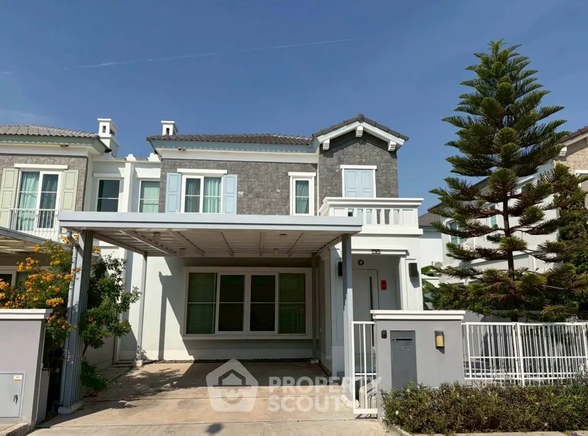 Charming two-story house with modern facade and spacious driveway in a serene neighborhood.