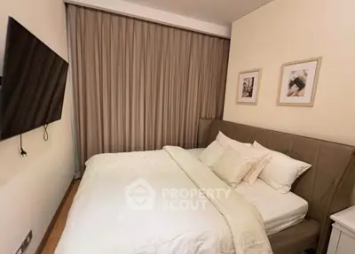 Cozy bedroom with modern decor and wall-mounted TV