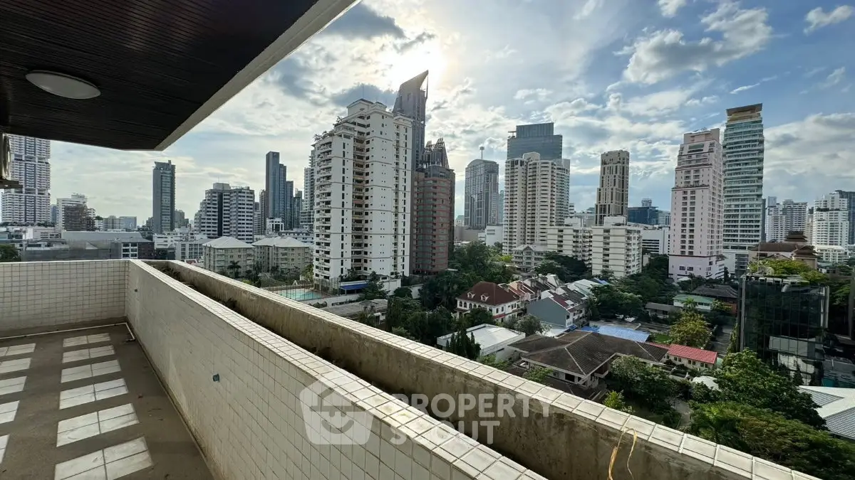 Stunning cityscape view from a spacious balcony in a high-rise building, perfect for urban living.