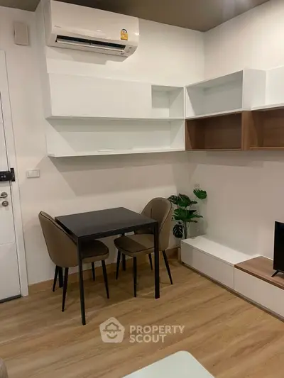 Modern living room with sleek furniture and air conditioning unit, perfect for cozy gatherings.