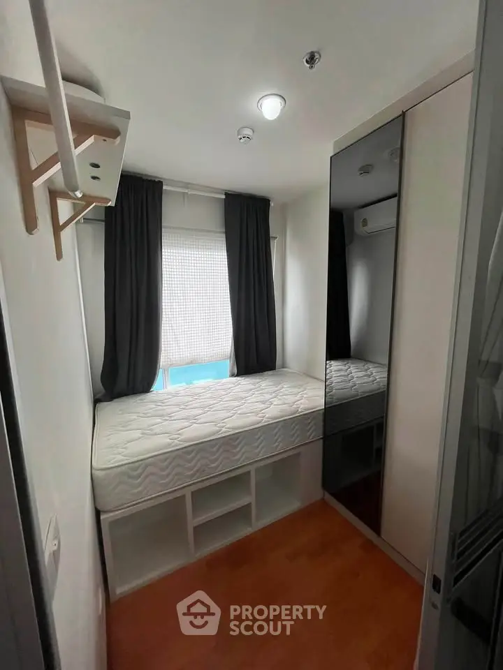 Compact bedroom with built-in storage and mirrored wardrobe, ideal for maximizing small spaces.