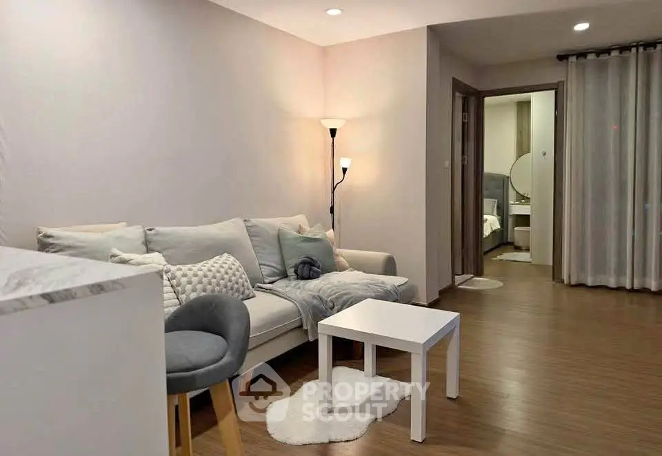 Modern living room with cozy sofa and stylish decor in open layout apartment.