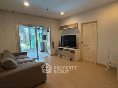 Spacious living room with modern decor and balcony access in a stylish apartment.