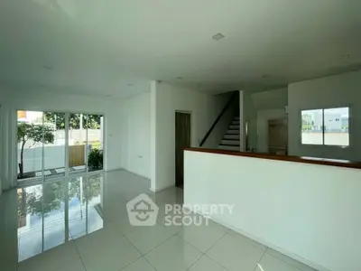 Spacious modern living room with sleek tile flooring and large windows