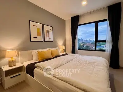 Cozy bedroom with city view, modern decor, and ample natural light.
