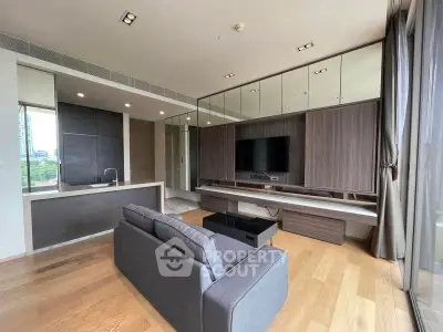 Modern living room with sleek design, large windows, and stylish furniture in a high-rise apartment.
