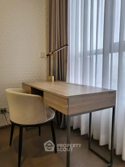 Modern study area with sleek desk and chair by large window, perfect for productivity.